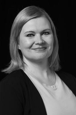 Black and white photo of a woman smiling.